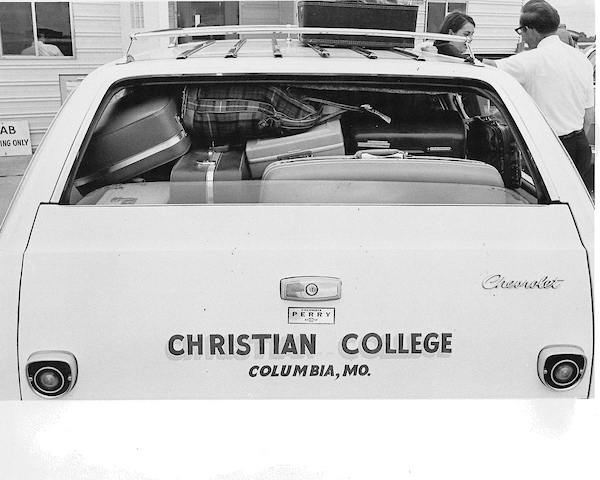 Historical image of the back of a station wagon loaded with luggage for students arriving at "Christian College" in Columbia, MO.