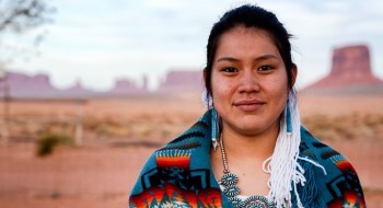 An indigenous woman smiling at the camera