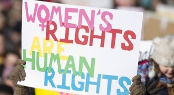 Multi-colored sign being held up that says "Women's Rights are Human Rights".