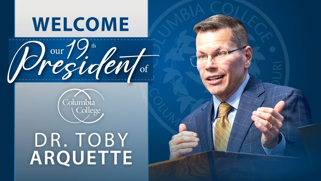 Dr. Toby Arquette, announced as Columbia College's 19th President on 12/22/2025, wearing a blue striped suit, gold tie, and glasses.