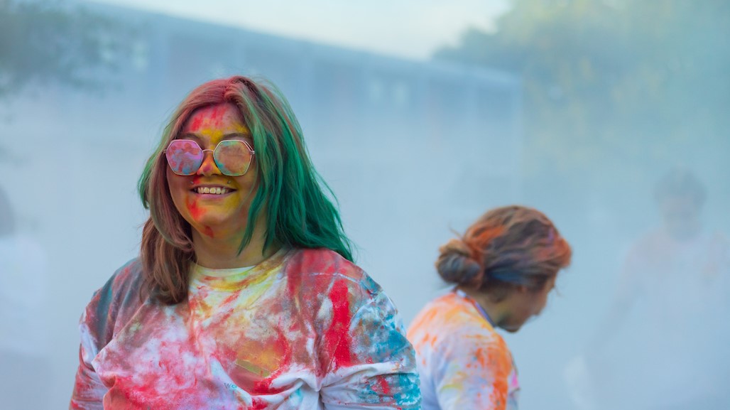 Two students, wearing a variety of colors after the events of the Color Run.