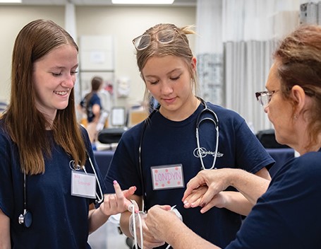 Three nursing open house attendees in discussion.