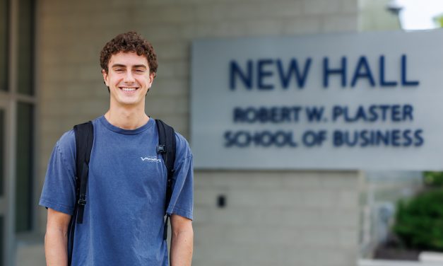 Columbia College senior Paul Morpurgo poses for a photo in front of New Hall, home of the Robert W. Plaster School of Business.