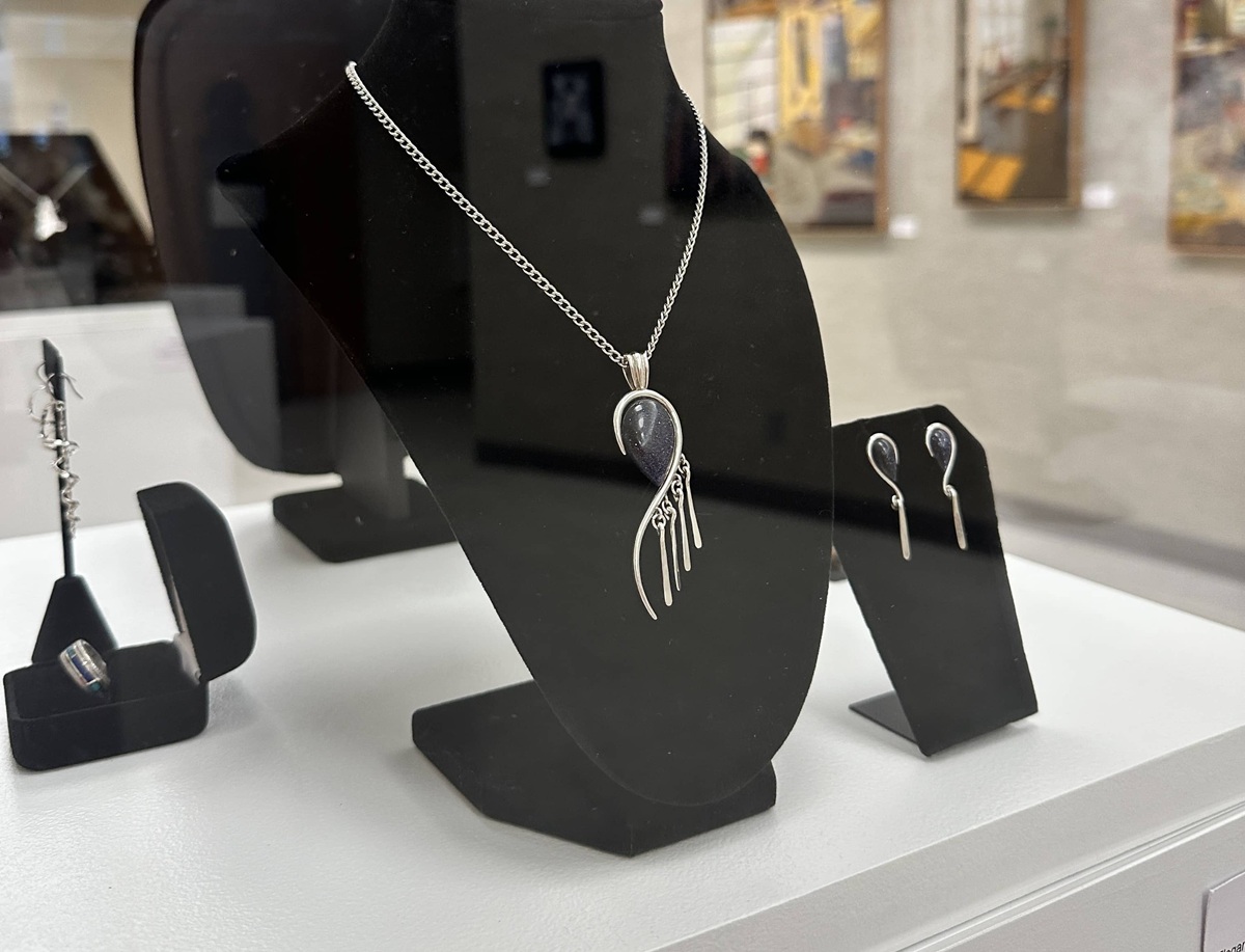 Necklace and earring set created by faculty member Bryan Page on display in the Sydney Larson gallery.