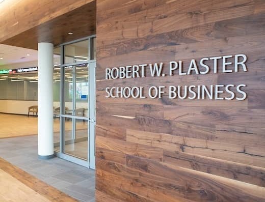 Close up of the Robert W.  Plaster School of Business sign inside of New Hall.