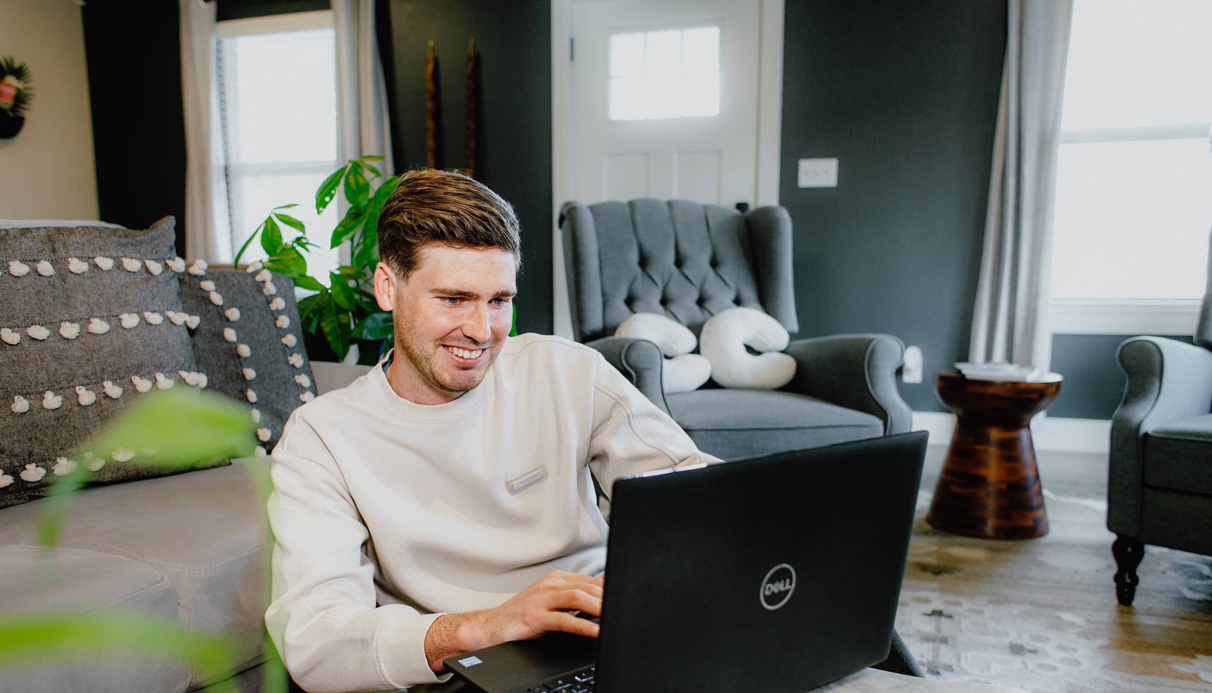 M.Ed. adult male student, sitting at home in front of his laptop, studying for his online Master of Education in Educational Leadership degree.