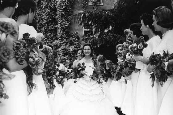 Women students dressed in white gowns celebrating the Ivy Chain ceremony.