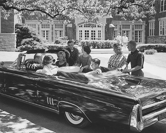 Historical image of Columbia College students gathering in and around an old convertible car.